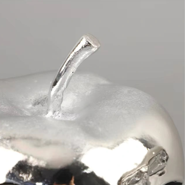 close up silver apple stem sculpture